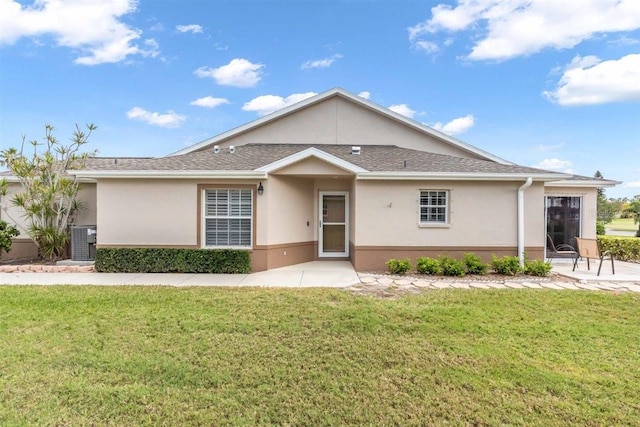 ranch-style house featuring a front lawn, central AC unit, a patio area, and stucco siding