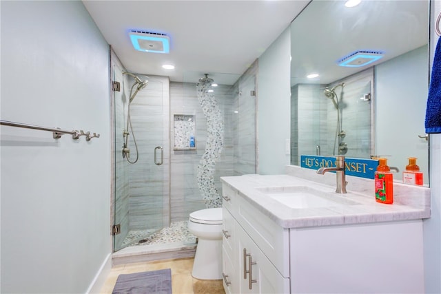 full bath with a stall shower, vanity, and toilet