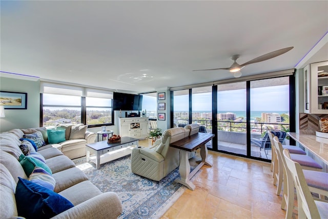 living area featuring stone tile flooring and floor to ceiling windows