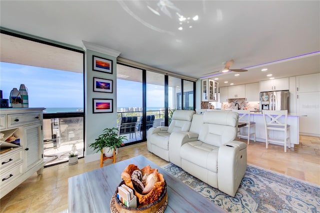 living room with expansive windows, ceiling fan, and recessed lighting