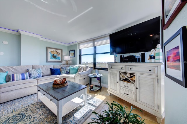 living room with crown molding, baseboards, and light tile patterned floors