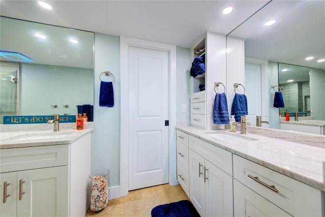 full bathroom with two vanities, a sink, and recessed lighting