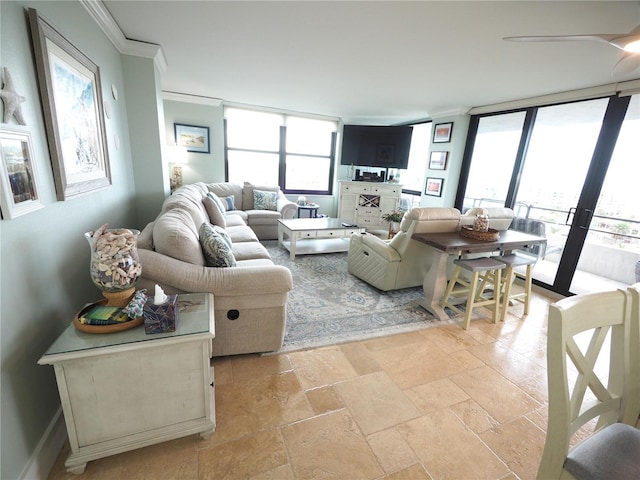 living room featuring expansive windows, stone tile flooring, crown molding, and baseboards