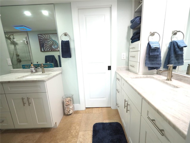 full bath featuring a shower, two vanities, and a sink