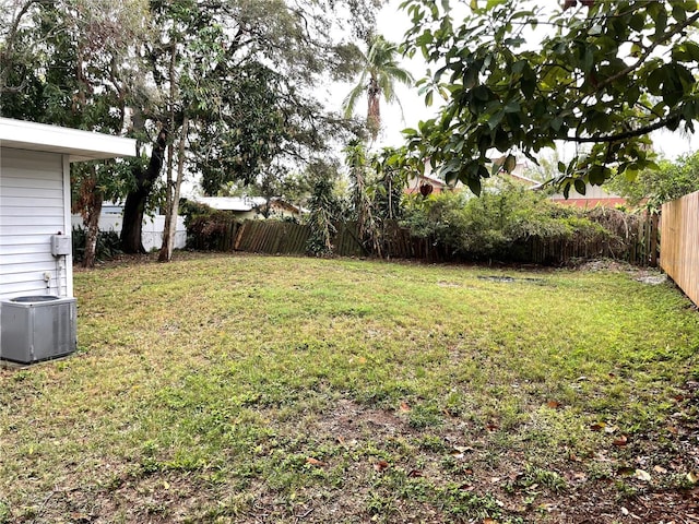 view of yard featuring central AC and a fenced backyard