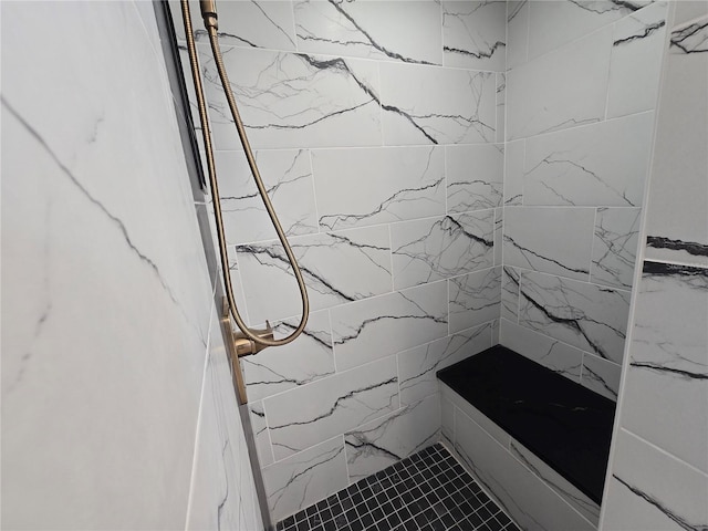 bathroom featuring a marble finish shower