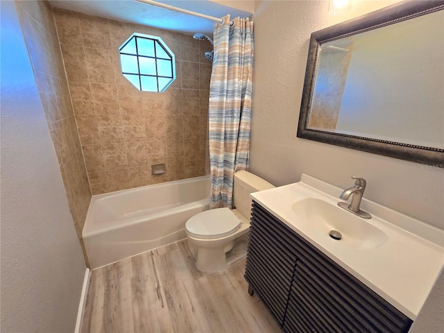 bathroom featuring a textured wall, toilet, wood finished floors, vanity, and shower / bathtub combination with curtain