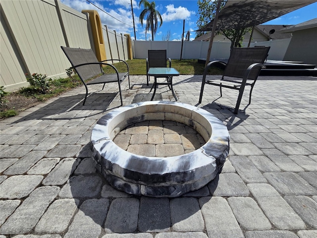 view of patio with an outdoor fire pit and a fenced backyard