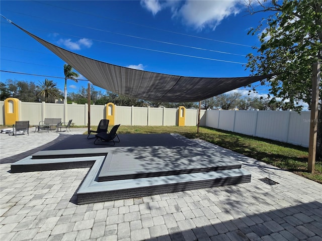 view of patio with a storage unit and a fenced backyard