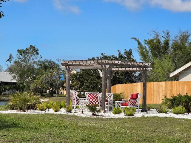 view of yard with fence and a pergola