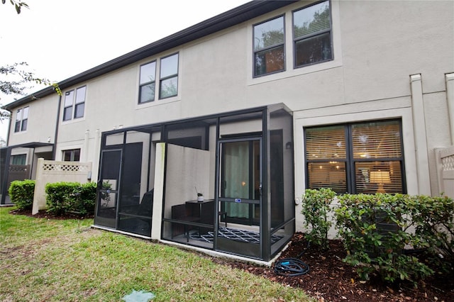 5118 78th St Cir E, Bradenton, FL 34203 - back of house with a yard, fence, a sunroom, and stucco siding