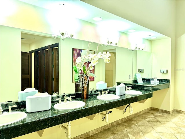 bathroom featuring baseboards and a sink