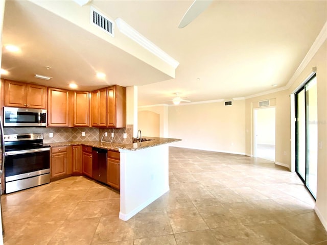 kitchen with brown cabinets, visible vents, appliances with stainless steel finishes, light stone countertops, and a peninsula