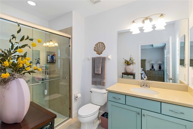 bathroom with toilet, a shower stall, vanity, and tile patterned floors