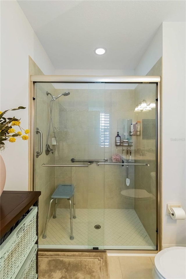 full bath with a stall shower, vanity, toilet, and tile patterned floors