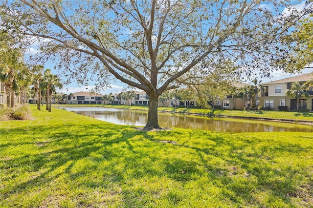 view of yard featuring a residential view and a water view