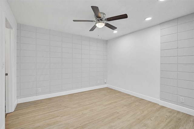 unfurnished room featuring light wood-type flooring, baseboards, and recessed lighting