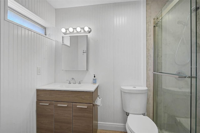 full bathroom with toilet, a stall shower, and vanity