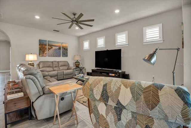 living room featuring light tile patterned floors, visible vents, arched walkways, ceiling fan, and recessed lighting