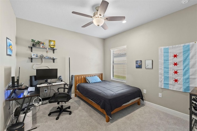 carpeted bedroom with a ceiling fan and baseboards