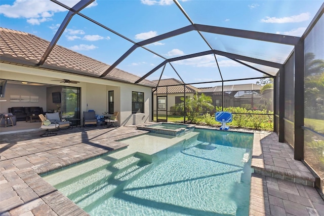 view of pool with ceiling fan, a patio, a lanai, and a pool with connected hot tub