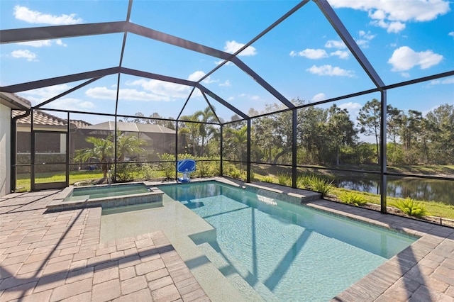 view of pool featuring a pool with connected hot tub, a water view, a patio, and a lanai