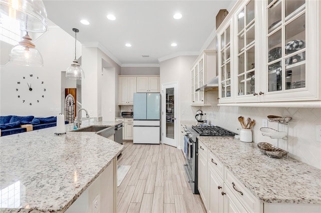 kitchen featuring open floor plan, appliances with stainless steel finishes, backsplash, and crown molding