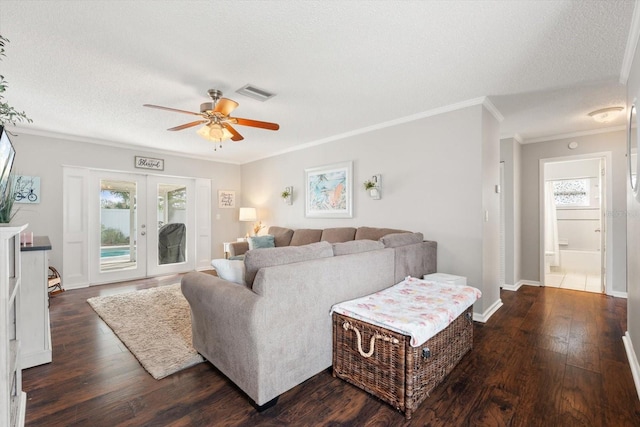 living area with a textured ceiling, french doors, dark wood-style flooring, and visible vents