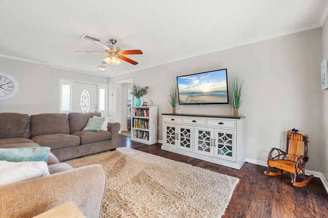 living area with dark wood finished floors, ornamental molding, a ceiling fan, a textured ceiling, and baseboards