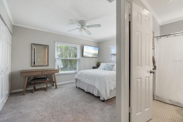 bedroom with crown molding, light carpet, ceiling fan, a textured ceiling, and baseboards