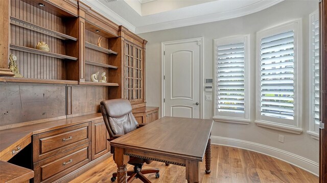 home office featuring light wood-style flooring, baseboards, and crown molding