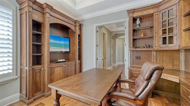 home office featuring ornamental molding, arched walkways, baseboards, and light wood finished floors