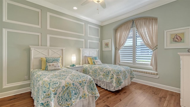 bedroom with ceiling fan, crown molding, baseboards, and wood finished floors