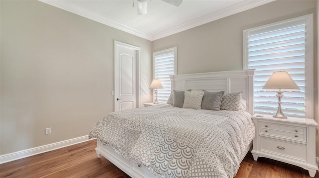 bedroom with a ceiling fan, baseboards, ornamental molding, and wood finished floors