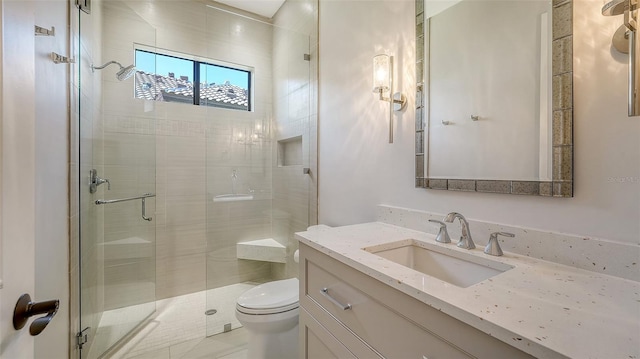 bathroom featuring a stall shower, vanity, and toilet