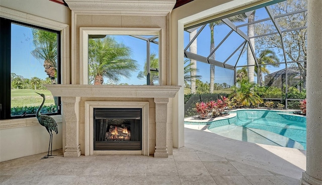 outdoor pool featuring a lanai, a patio, and a lit fireplace