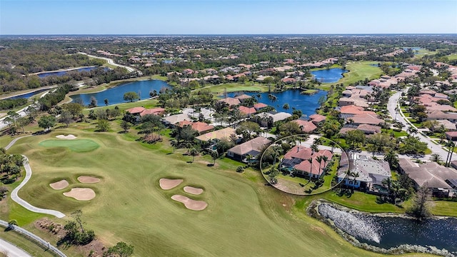 aerial view featuring view of golf course, a water view, and a residential view