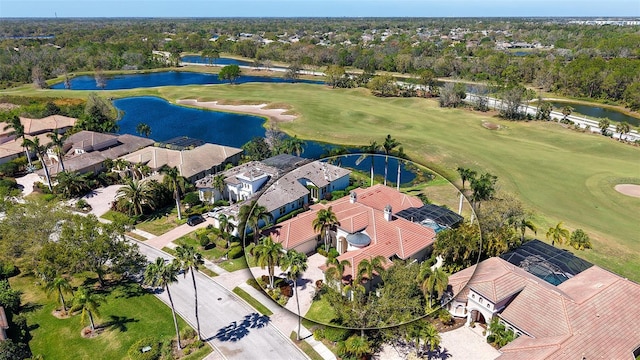 birds eye view of property featuring golf course view, a water view, and a residential view