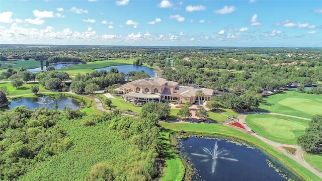 birds eye view of property with view of golf course and a water view