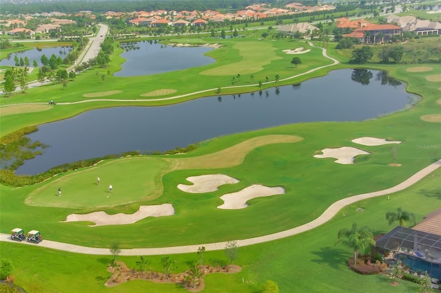 birds eye view of property featuring a water view and golf course view