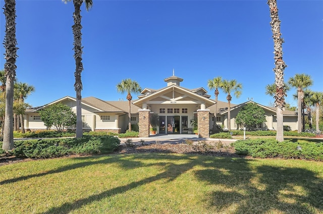 back of property featuring a garage, a lawn, and driveway