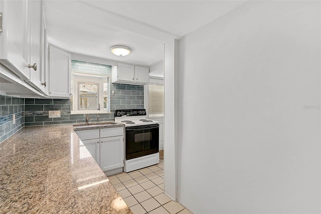 kitchen with range with electric cooktop, white cabinets, a sink, and backsplash