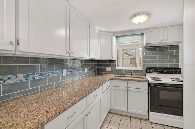 kitchen featuring light tile patterned floors, decorative backsplash, electric stove, white cabinetry, and a sink