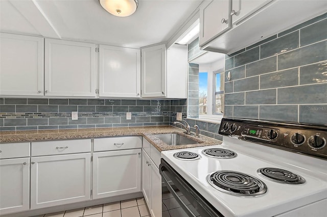 kitchen featuring electric range, backsplash, a sink, and white cabinets