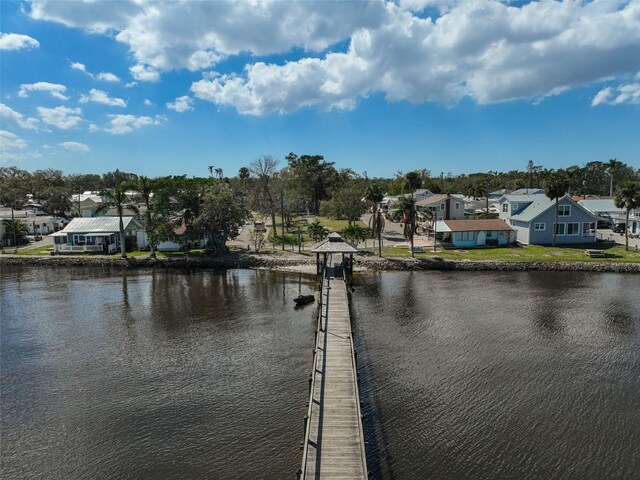 dock area with a residential view and a water view