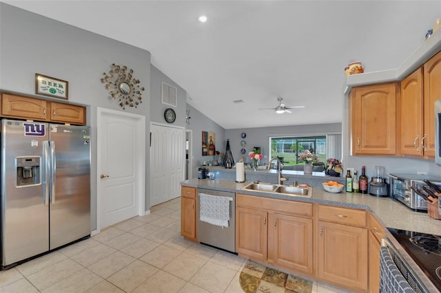 kitchen featuring ceiling fan, appliances with stainless steel finishes, vaulted ceiling, light countertops, and a sink