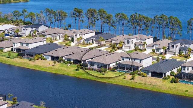 birds eye view of property featuring a residential view and a water view