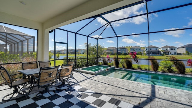 view of pool with a residential view, a lanai, a patio area, and a pool with connected hot tub