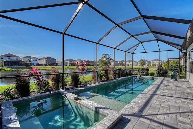 view of pool with a lanai, a water view, a pool with connected hot tub, a residential view, and a patio area