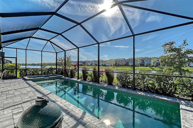 view of pool featuring glass enclosure, a patio area, a residential view, and a pool with connected hot tub